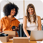 Two business women looking at a computer.